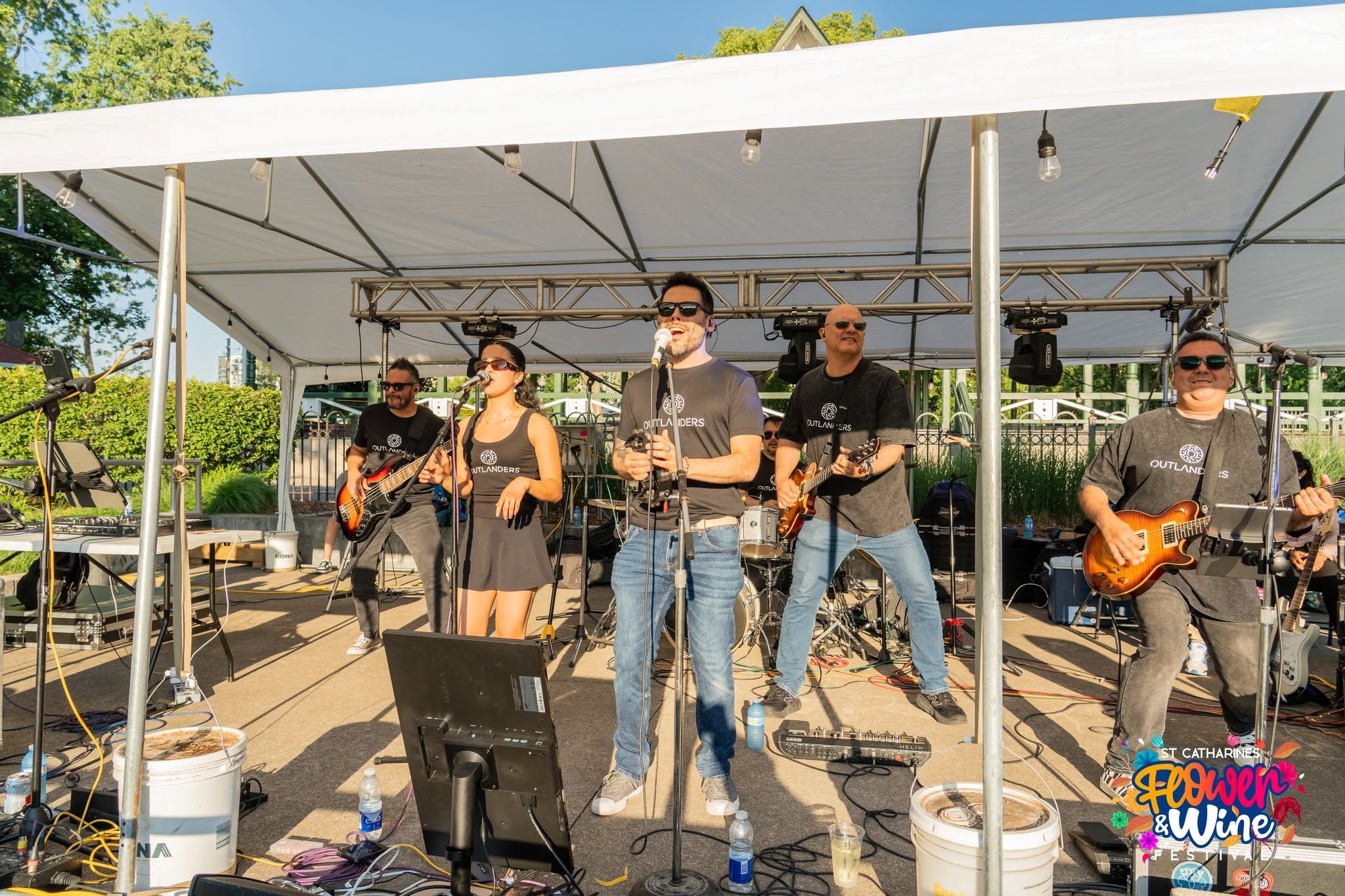 Outdoor band performing under a canopy at the St. Catharine’s Flower & Wine Festival.
